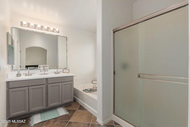 bathroom featuring double vanity, a shower stall, a sink, and a bath