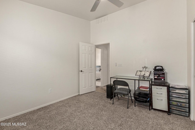 carpeted office featuring baseboards, a ceiling fan, and visible vents