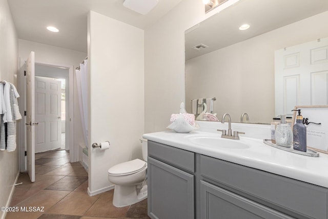 full bath with a shower with curtain, visible vents, vanity, tile patterned floors, and toilet