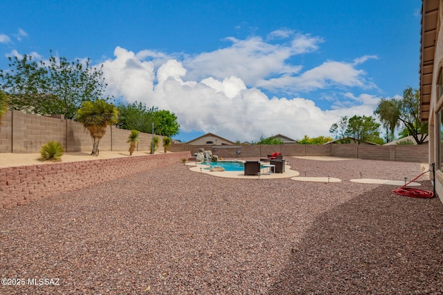 view of yard with a fenced in pool, a fenced backyard, and a patio area