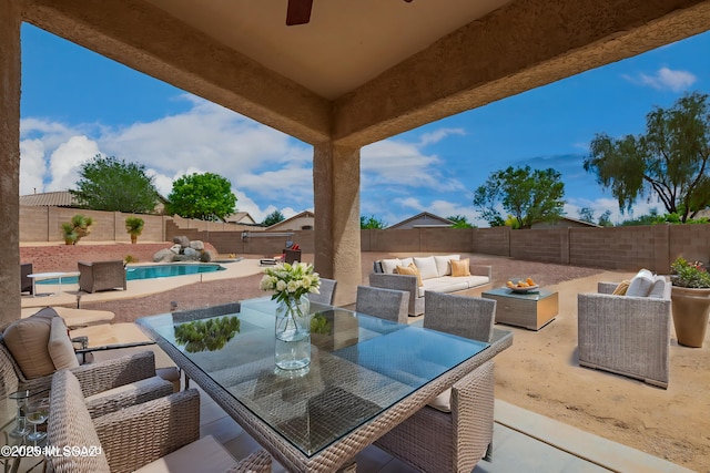 view of patio featuring an outdoor living space, a fenced backyard, outdoor dining space, and a fenced in pool
