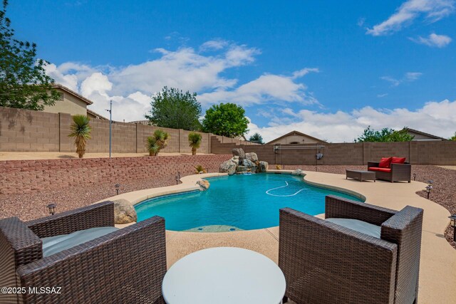 view of pool with a fenced in pool, a fenced backyard, outdoor lounge area, and a patio area
