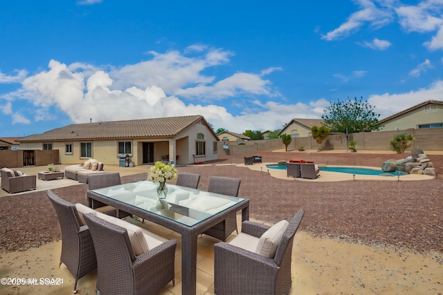 view of patio / terrace with an outdoor hangout area, a fenced in pool, outdoor dining space, and a fenced backyard