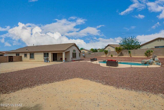exterior space featuring a fenced backyard, stucco siding, a patio area, and a tile roof