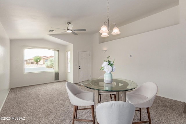 dining space featuring vaulted ceiling, carpet flooring, ceiling fan with notable chandelier, and visible vents