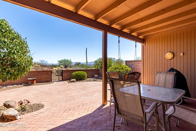 view of patio with outdoor dining area and a fenced backyard