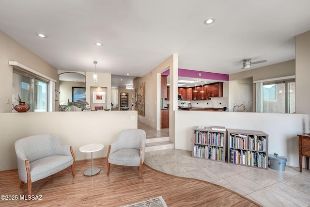 sitting room with recessed lighting, light wood-style flooring, and a ceiling fan