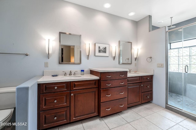 bathroom with tile patterned floors, a stall shower, toilet, and vanity