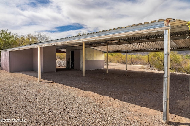 view of vehicle parking featuring an exterior structure