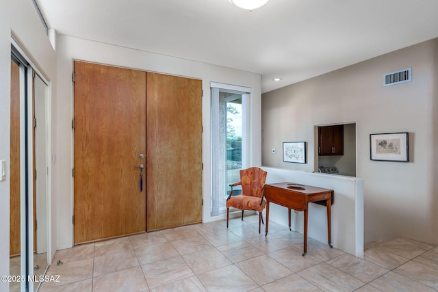 entryway with light tile patterned floors and visible vents