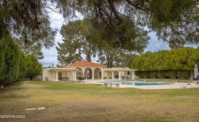 2714 W Magee Rd, Tucson, AZ 85742 - back of property with a lawn, a tile roof, an outdoor pool, and stucco siding