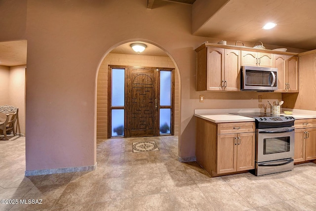 kitchen featuring light countertops and appliances with stainless steel finishes