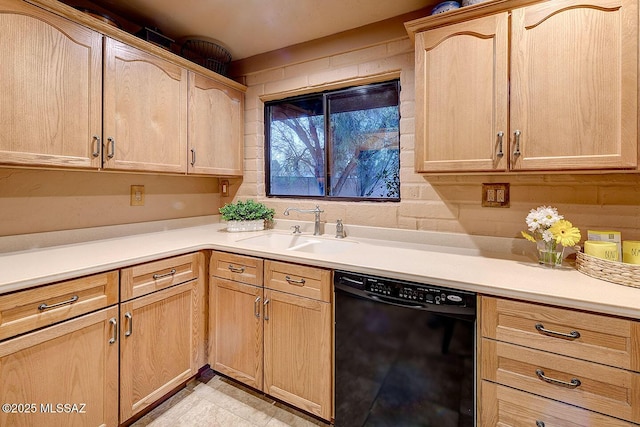 kitchen featuring light brown cabinets, light countertops, a sink, and black dishwasher