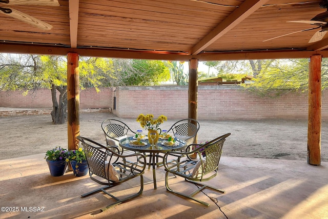 view of patio / terrace featuring a fenced backyard, a ceiling fan, and outdoor dining area