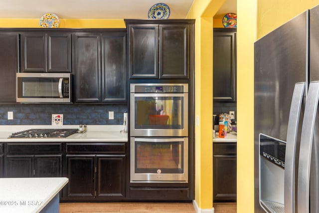 kitchen featuring backsplash, stainless steel appliances, and light countertops