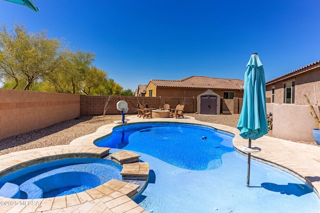 view of pool with a storage shed, a pool with connected hot tub, a patio, and a fenced backyard