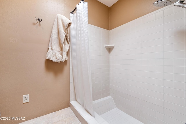 bathroom with tiled shower