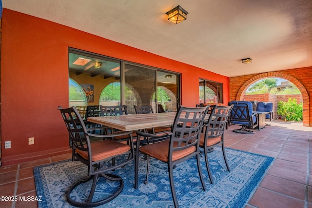 dining space featuring baseboards and tile patterned flooring