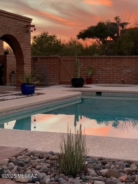 view of pool featuring a gate, a fenced in pool, and fence