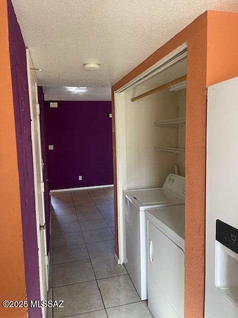 3800 E 2nd St # 111, Tucson, AZ 85716 - laundry area with independent washer and dryer, light tile patterned floors, and a textured ceiling