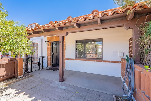 rear view of property with a porch and stucco siding