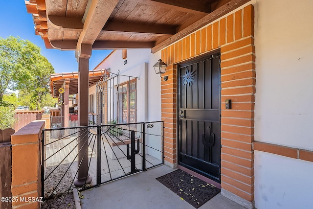 view of exterior entry with fence