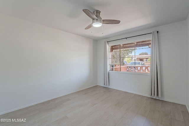 spare room featuring ceiling fan and light wood finished floors