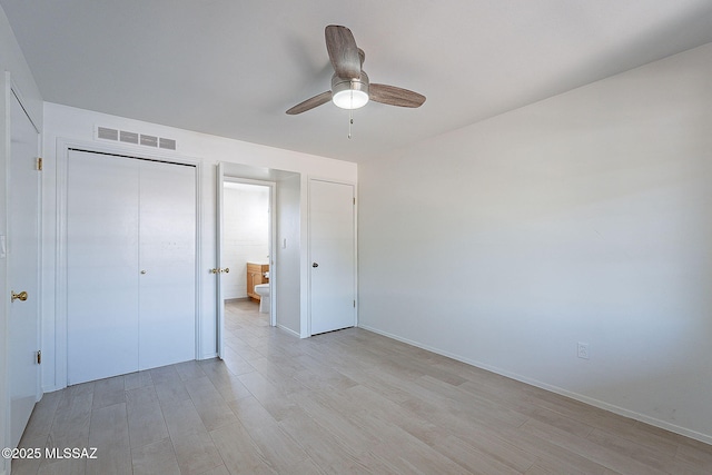 unfurnished bedroom featuring visible vents, a ceiling fan, light wood-type flooring, and a closet