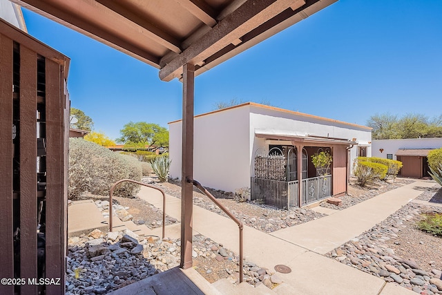 exterior space with fence and stucco siding