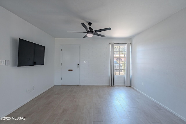 unfurnished living room with light wood-style floors, a ceiling fan, and baseboards