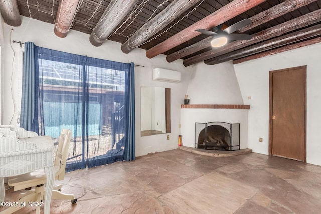 unfurnished living room featuring an AC wall unit, beamed ceiling, a large fireplace, ceiling fan, and wooden ceiling