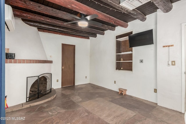 unfurnished living room featuring beamed ceiling, a ceiling fan, a wall mounted air conditioner, a fireplace, and wooden ceiling