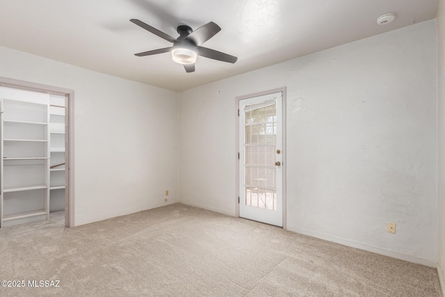 empty room featuring carpet and ceiling fan