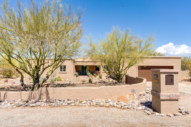 6261 N Placita De Rojelio, Tucson, AZ 85718 - pueblo revival-style home with stucco siding and driveway