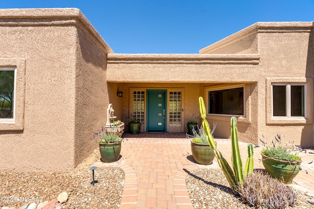 6261 N Placita De Rojelio, Tucson, AZ 85718 - doorway to property featuring stucco siding and a patio area
