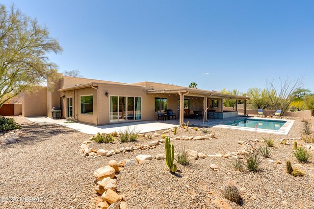 6261 N Placita De Rojelio, Tucson, AZ 85718 - back of house with stucco siding and a patio