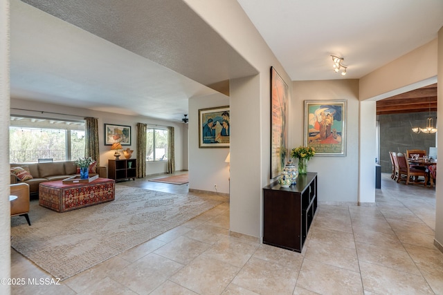 6261 N Placita De Rojelio, Tucson, AZ 85718 - corridor with light tile patterned floors and a chandelier