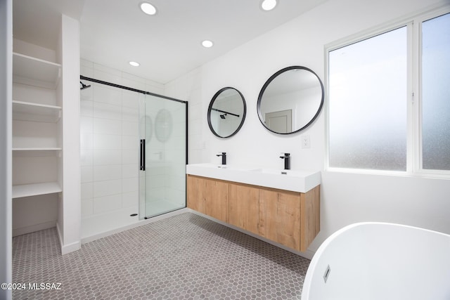 full bath with double vanity, a stall shower, a sink, a soaking tub, and recessed lighting