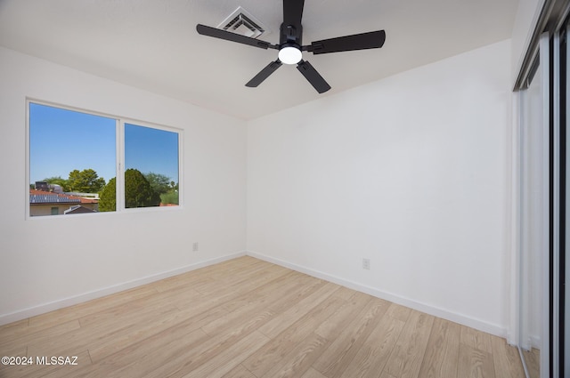 unfurnished bedroom with visible vents, baseboards, ceiling fan, and wood finished floors