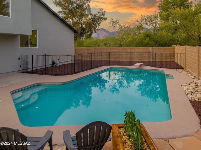 view of swimming pool featuring a fenced in pool, a fenced backyard, and a patio area