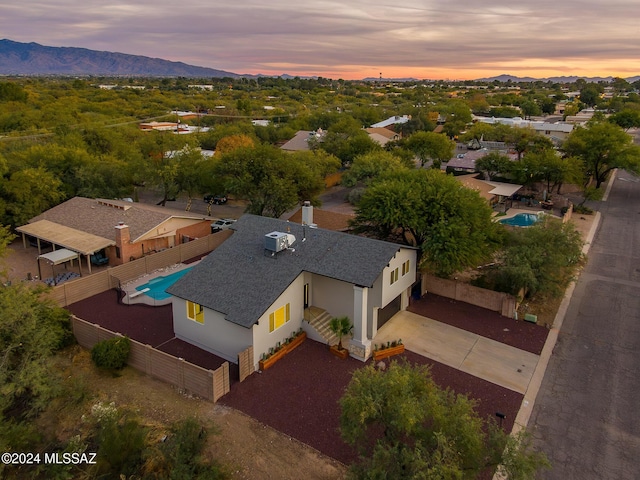 aerial view at dusk featuring a mountain view
