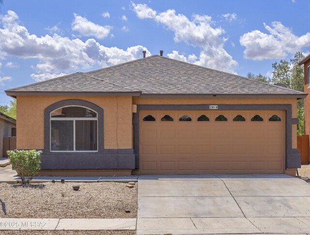 2414 E Calle Lena Verde, Tucson, AZ 85706 - view of front facade with a shingled roof, concrete driveway, a garage, and stucco siding