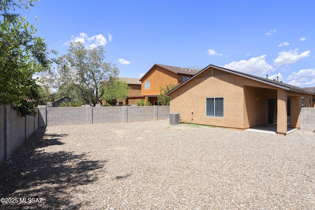 2414 E Calle Lena Verde, Tucson, AZ 85706 - back of property featuring stucco siding, central AC, a fenced backyard, and a patio area