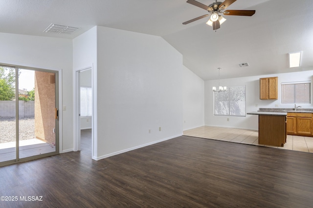 2414 E Calle Lena Verde, Tucson, AZ 85706 - unfurnished living room with a chandelier, light wood-type flooring, ceiling fan, vaulted ceiling, and a sink