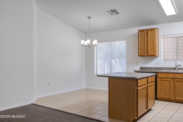 2414 E Calle Lena Verde, Tucson, AZ 85706 - kitchen featuring a sink, dark countertops, a chandelier, lofted ceiling, and hanging light fixtures