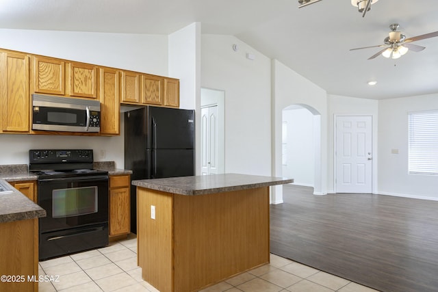 2414 E Calle Lena Verde, Tucson, AZ 85706 - kitchen with black appliances, arched walkways, dark countertops, ceiling fan, and high vaulted ceiling