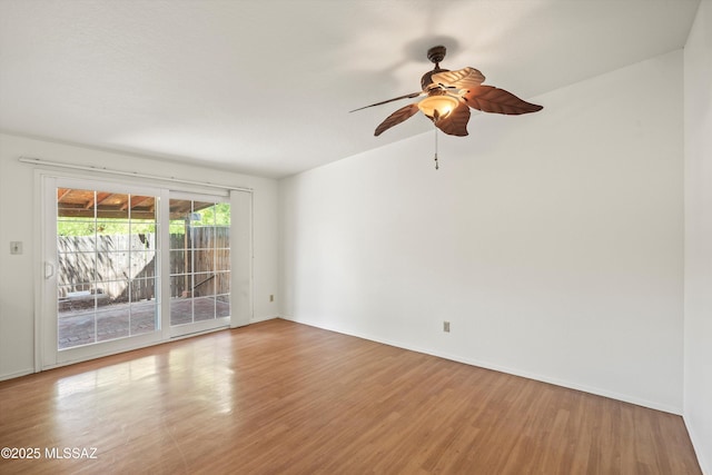 9770 E Hollow Pl, Tucson, AZ 85748 - spare room featuring baseboards, a ceiling fan, and wood finished floors