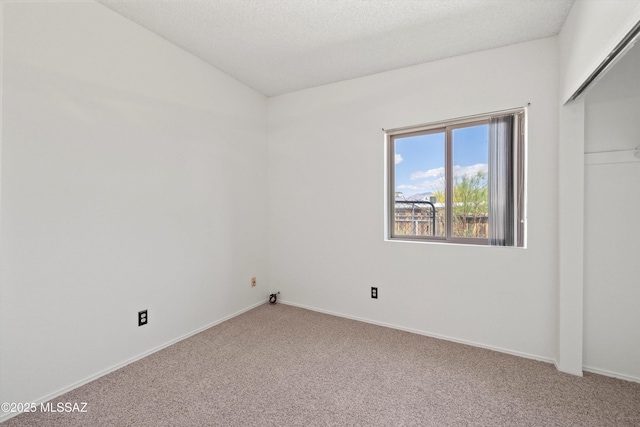 9770 E Hollow Pl, Tucson, AZ 85748 - empty room with vaulted ceiling, a textured ceiling, carpet flooring, and baseboards