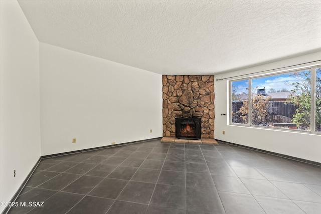 9770 E Hollow Pl, Tucson, AZ 85748 - unfurnished living room featuring tile patterned floors, a fireplace, baseboards, and a textured ceiling