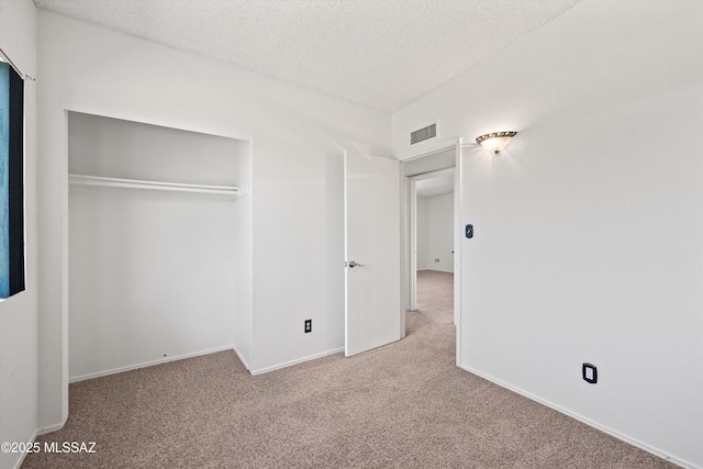 9770 E Hollow Pl, Tucson, AZ 85748 - unfurnished bedroom featuring a textured ceiling, a closet, baseboards, carpet flooring, and visible vents